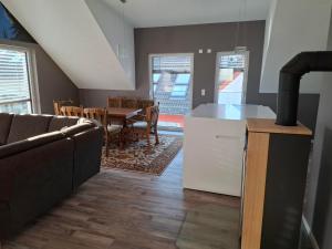 a kitchen and dining room with a couch and a table at Smartliving 85 in Aßlar