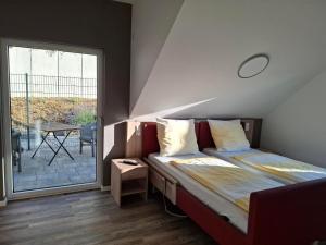 a bedroom with two beds and a large window at Smartliving 85 in Aßlar +29 photos