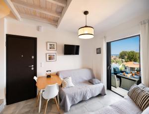 a living room with a couch and a table at Hippothoi Sea View Maisonette in Mesochórion
