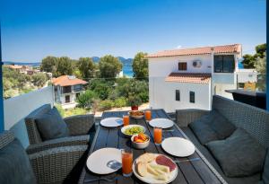 a table with food on top of a balcony at Hippothoi Sea View Maisonette in Mesochórion