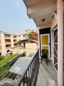 a balcony with a table and a chair on it at Lux Apartment in Kathmandu