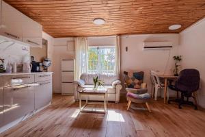 a kitchen and living room with a table and a couch at Bright 2 Bedroom, Private Garden in Herzliya