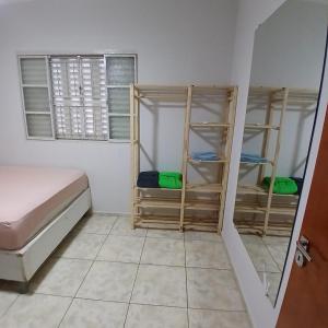 a room with a bed and a room with bunk beds at Sobrado Morada do Sol! in Uberaba