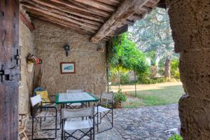 an outdoor patio with a table and chairs at Borgo Rinascimento in Farnese