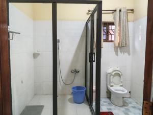 a bathroom with a shower and a toilet at Royal Irenic Hotel in Madina