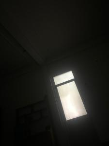 a light in a room with a window at Dubai in Thuong Thon