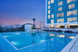 a swimming pool in front of a building at Crowne Plaza Bandung by IHG in Bandung