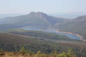 a view of a lake in a valley with mountains at Malhada Do Rei Mountain House in Pampilhosa da Serra