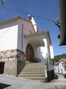 a small church with stairs leading to a door at Malhada Do Rei Mountain House in Pampilhosa da Serra