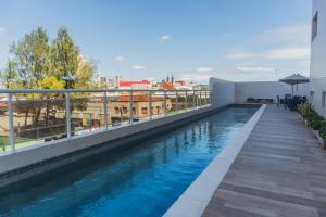a swimming pool on the roof of a building at Apartamento Bitú in Fortaleza