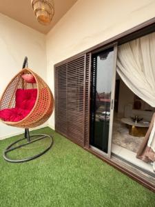 a room with a hammock in the corner of a room at 2bedroom Harmony Apartment in Abuja
