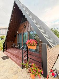a small house with a metal roof and potted plants at Ananta in Kobuleti
