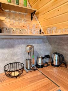 a kitchen counter with a mixer and pots and glasses at Ananta in Kobuleti