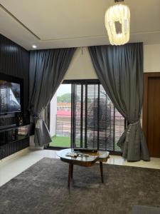 a living room with a table and a large window at 2bedroom Harmony Apartment in Abuja +16 photos