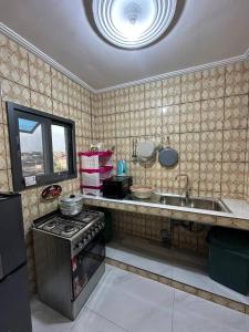 a kitchen with a stove and a sink at Suite premium in Douala