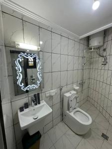 a bathroom with a toilet and a sink at Suite premium in Douala