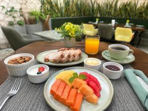 a wooden table with plates of food on it at Casa del Viento by ÓOL Hotels in Holbox Island