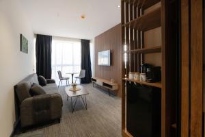 a living room with a couch and a table at NOVA LUXE Hotel & Residences in Batumi