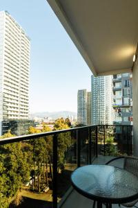 a balcony with a table and a view of a city at NOVA LUXE Hotel & Residences in Batumi
