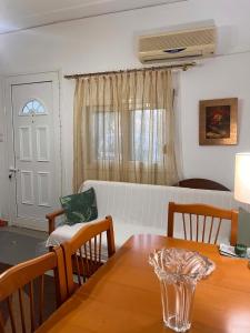 a living room with a table and a white couch at Theofania House Kanali in Kanali +7 photos
