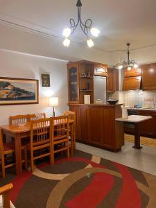 a kitchen and dining room with a table and chairs at Theofania House Kanali in Kanali