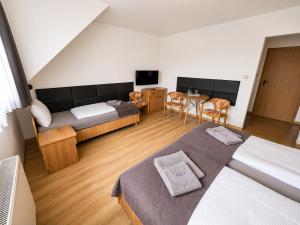 a bedroom with a bed and a table and chairs at Dom Wczasowy Larix in Rewal
