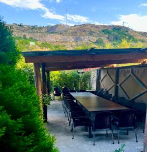 a table and chairs sitting under a wooden pergola at Rest Concept in Kʼanakʼerravan