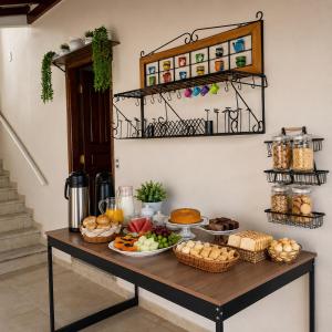 a table with food on top of it at Pousada Bem Estar Frutal in Frutal