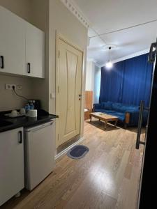 a kitchen and a living room with a blue couch at Riwaner Hotel in Avcılar +22 photos