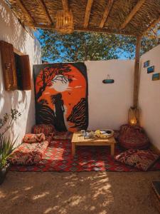 a room with a table and a painting on the wall at Cozy Dahab Studio with Private Courtyard in Dahab