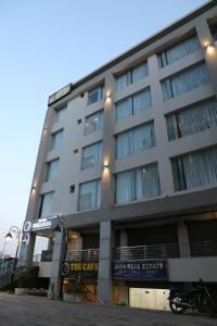 a large building with a sign in front of it at Hotel Helios in Zirakpur