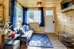a living room with a couch and a table at Fire Pit, Gas Grill! Bright Cottage By Devils Lake in Manitou Beach