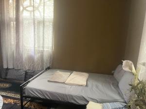 a bed in a room with two pillows on it at Djilani Global Hub in Dirē Dawa
