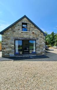 a stone building with a window on the side of it at Bundoran Holiday Letting in Bundoran