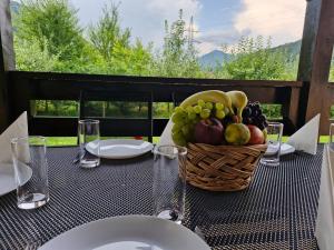 a table with a basket of fruit on it at Carpen View Residence in Săcele