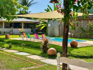 a backyard with chairs and a swimming pool at Morada das Dunas in Atins