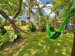 a hammock hanging from a tree in a yard at Morada das Dunas in Atins
