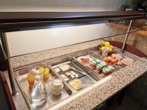 a refrigerator with food and drinks on a counter at Auberge Du Riou in Puget-Rostang