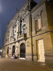 a large white building with a door on a street at Mini Apartment Ares 3 in Lima