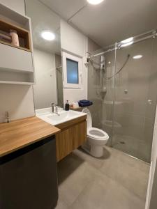 a bathroom with a shower and a sink and a toilet at Mini Apartment Ares 3 in Lima +22 photos