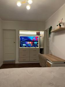 a living room with a large television in a room at Mini Apartment Ares 3 in Lima