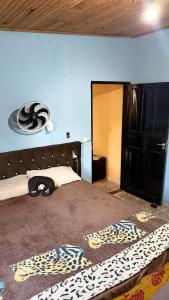 a bedroom with a bed with a black headboard at Casa in Barretos