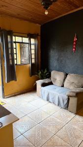 a living room with a couch and a window at Casa in Barretos