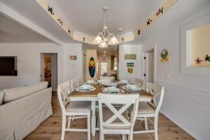 a dining room with a table and chairs and a couch at 275 Ohio in Fort Myers Beach