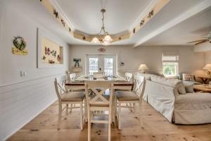 a dining room and living room with a table and chairs at 275 Ohio in Fort Myers Beach