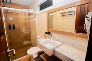 a bathroom with a sink and a shower at Landruá Flat in São Luís +25 photos