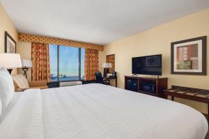 a hotel room with a bed and a television at Pier House 60 Clearwater Beach Marina Hotel in Clearwater Beach
