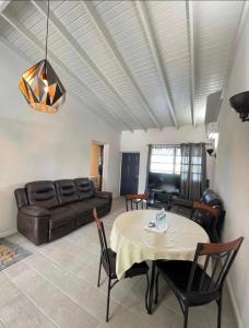 a living room with a table and a couch at Brightridge Condos in Bridgetown
