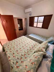 a bedroom with two beds and a window at Casa de Temporada Ipê Rosa in Bonito +67 photos
