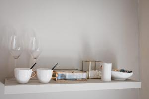 a shelf with wine glasses and bowls on it at Onder de Linde B&B in Valkenburg +10 photos